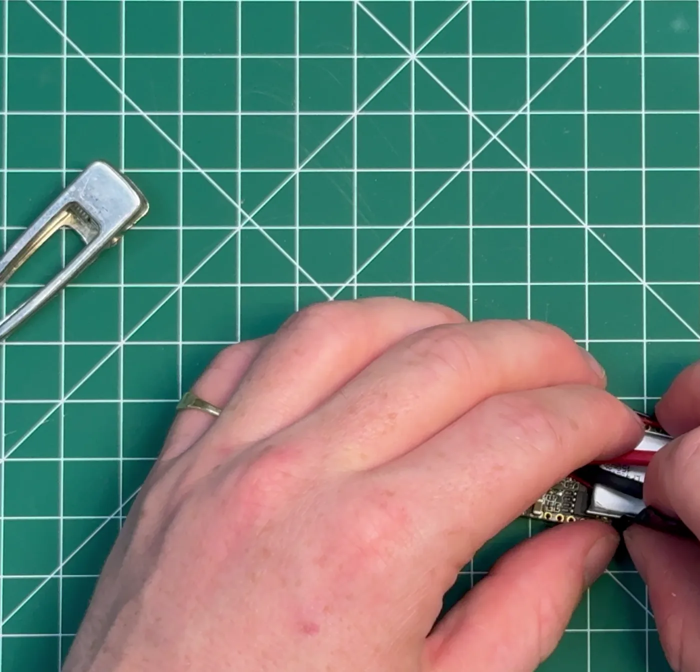 Lining the metal hair clip up against the back of the assembled board.