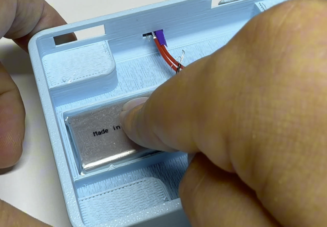 Pressing the LiPo into its pocket, switch wires folded out of the way.